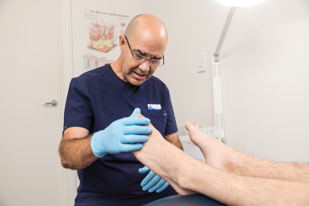 Clinician assessing a patient's foot